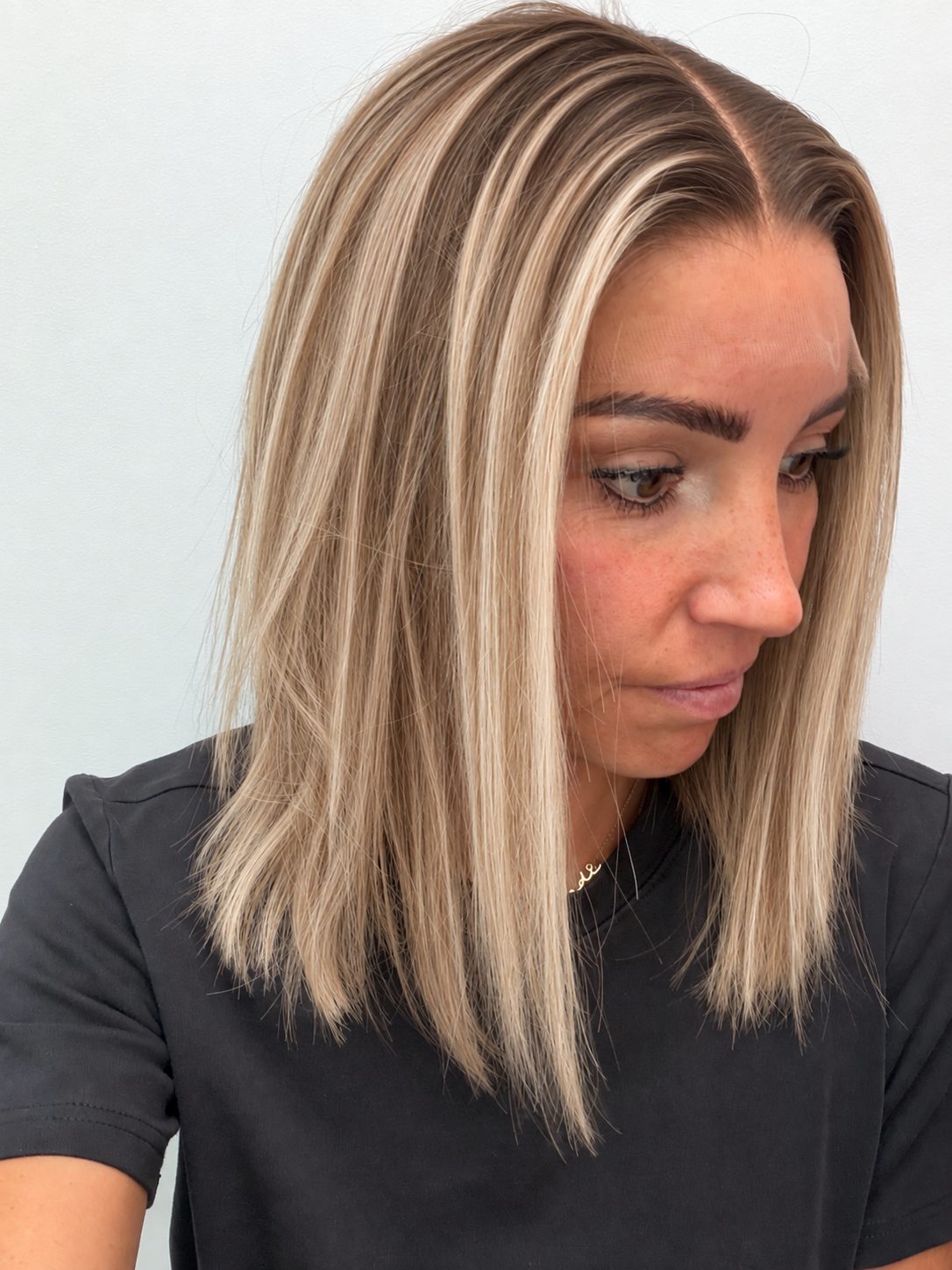 Champagne Melt 14-inch blunt bob wig in rooted champagne blonde balayage, side view showing the hairline
