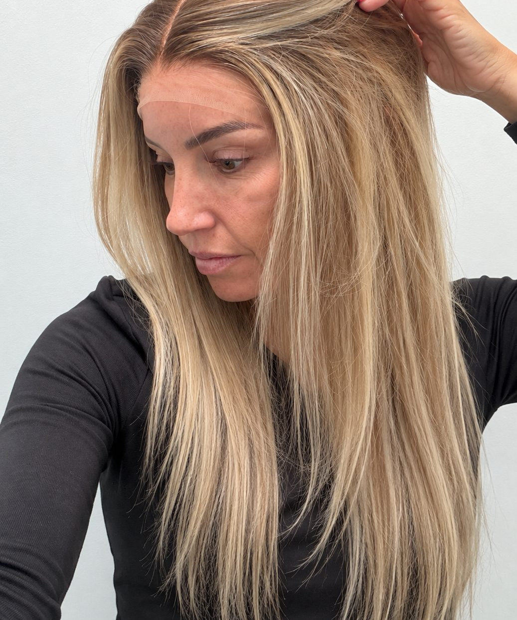 Champagne Melt 20-inch straight wig in rooted champagne blonde balayage, side view showing the hairline
