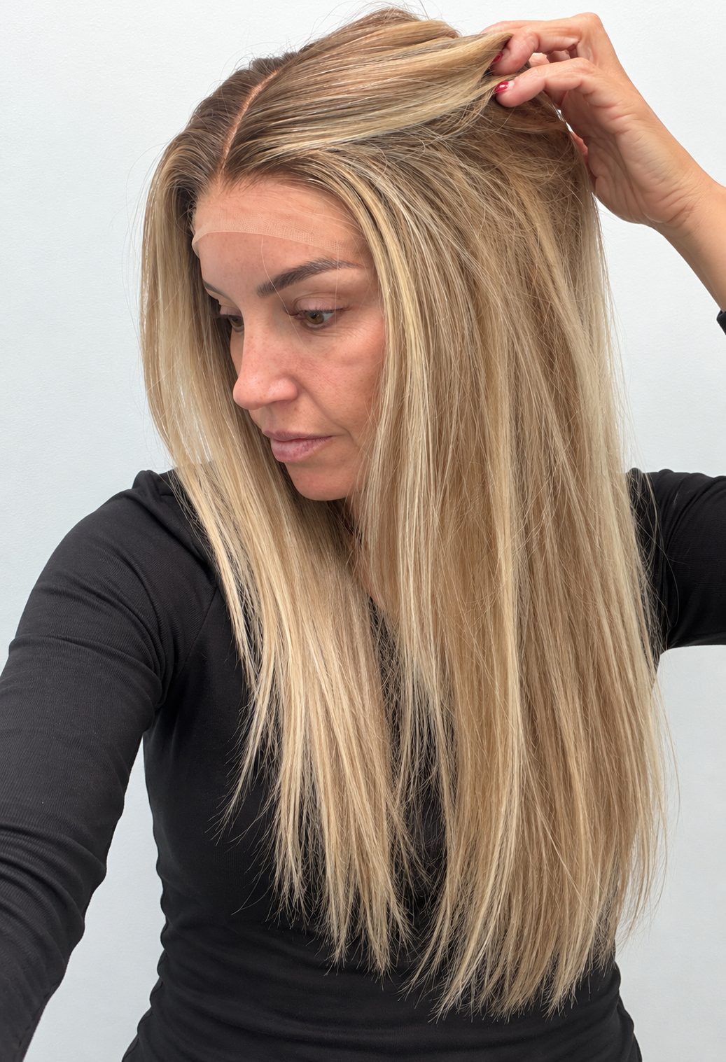 Champagne Melt 24-inch straight wig in rooted champagne blonde balayage, side view showing the hairline