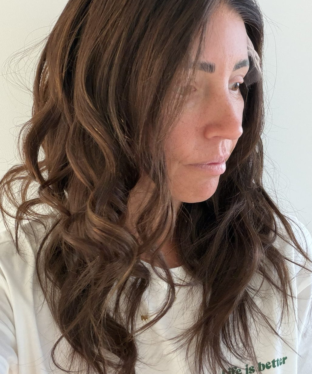 Cinnamon Spice 22-inch wavy wig in warm chocolate brown, side view showing the hairline