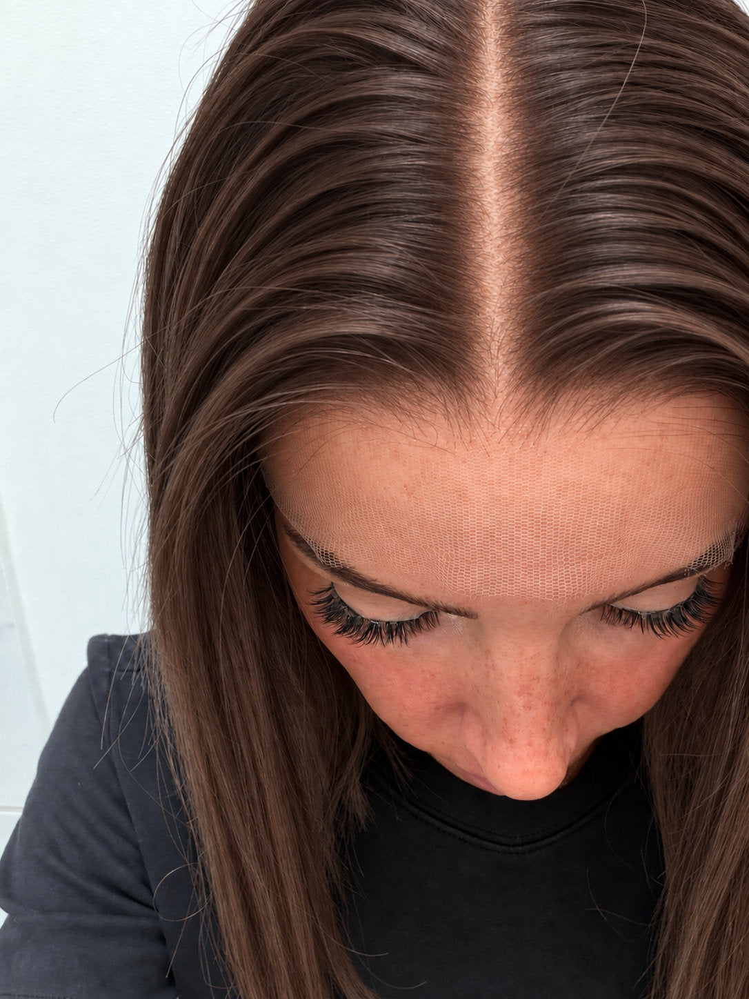 Close-up of the natural lace hairline and parting on a Cocoa human hair wig in warm medium cocoa brown