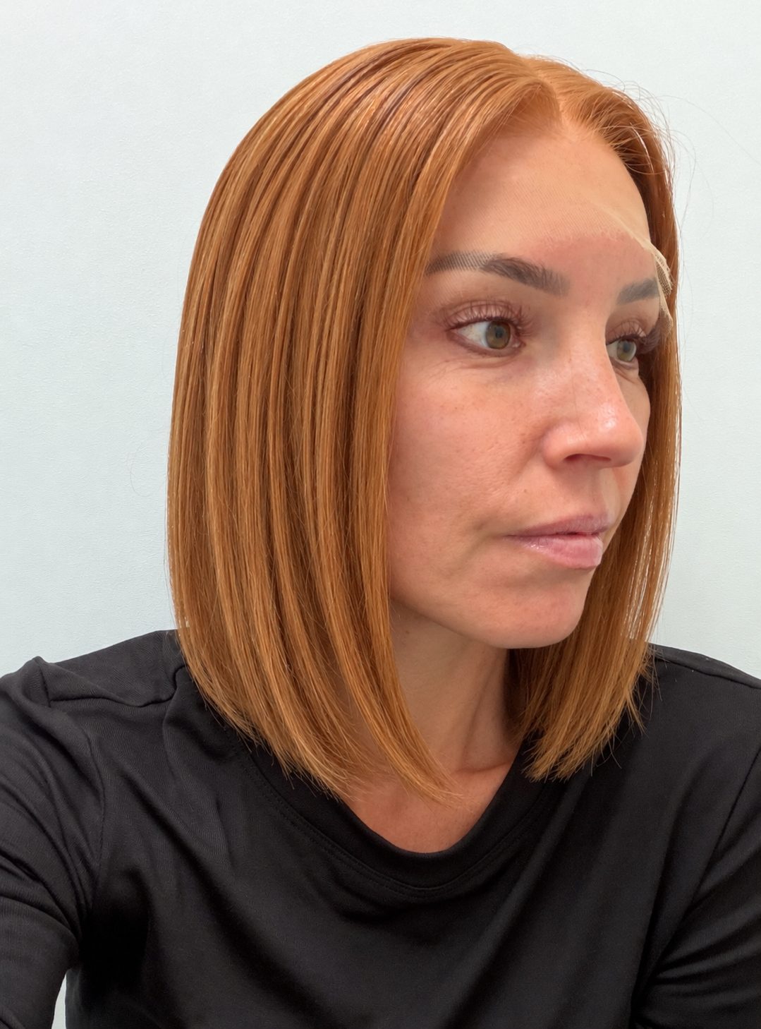 Copper Glow 12-inch straight wig in bright copper red, side view showing the hairline
