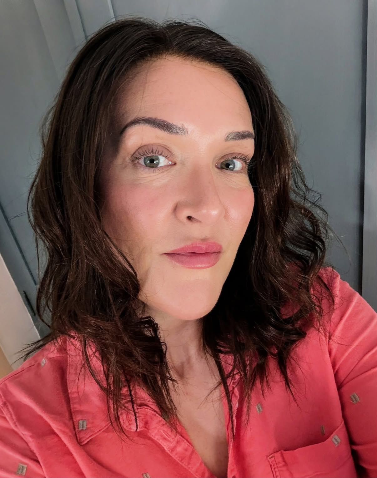 Customer wearing a dark brown wavy mid-length wig