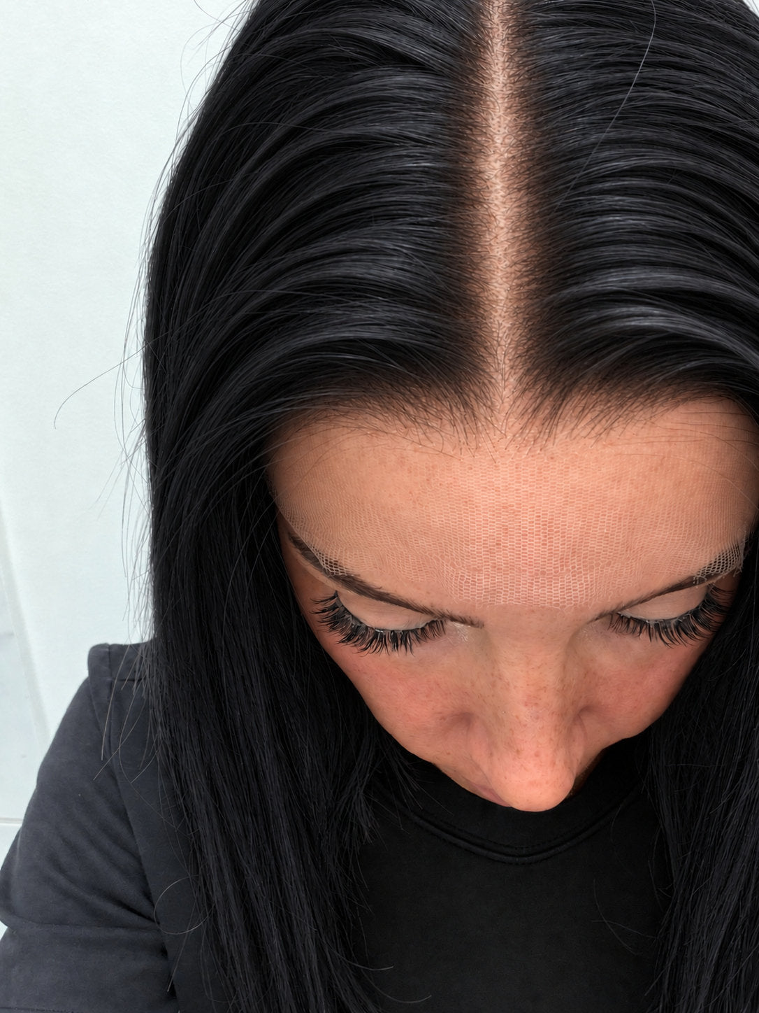 Close-up of the natural lace hairline and parting on a Midnight human hair wig in jet black