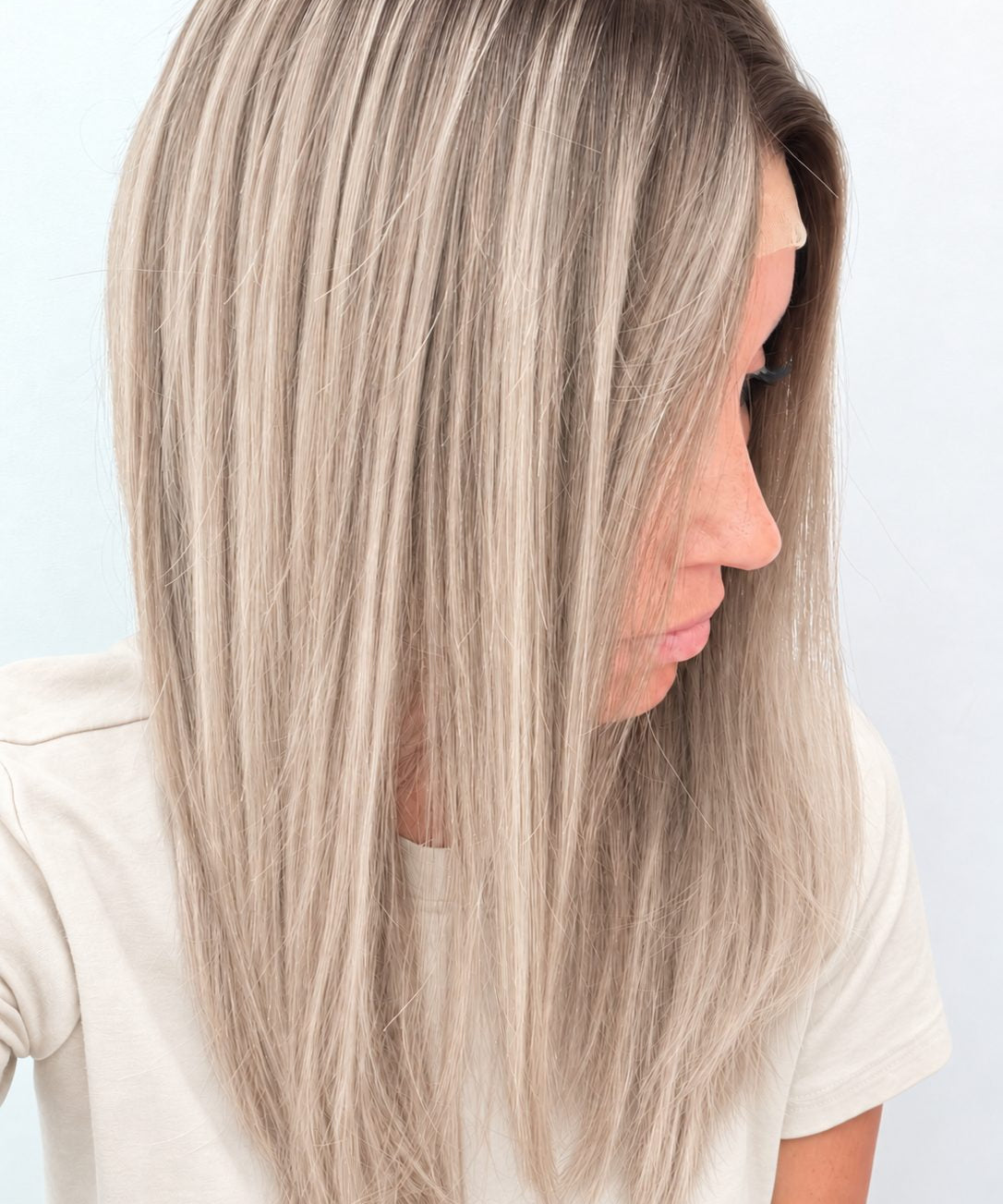 Nordic Pearl 18-inch layered straight wig in rooted platinum blonde, side view showing the hairline