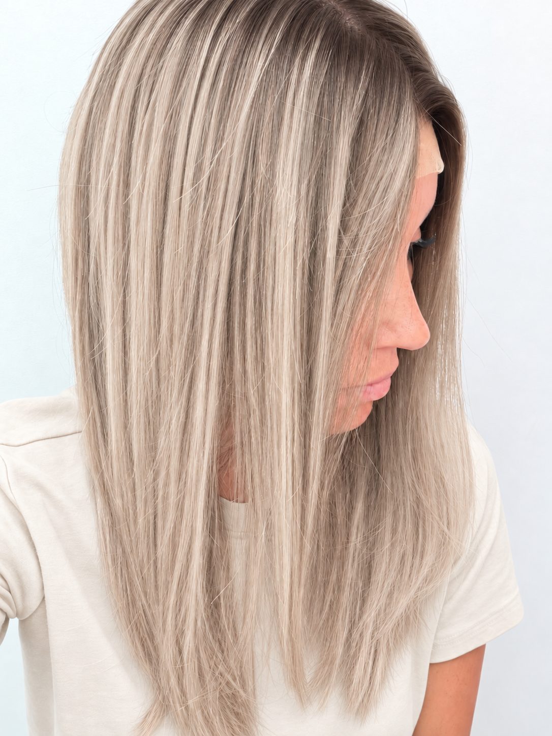 Nordic Pearl 18-inch layered straight wig in rooted platinum blonde, side view showing the hairline