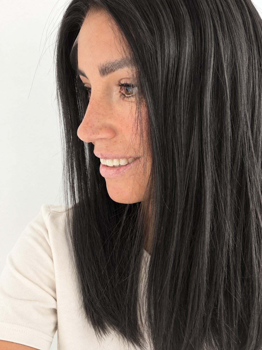 Soft Onyx 16-inch layered straight wig in soft natural black, side view showing the hairline