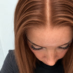 Close-up of the natural lace hairline and parting on a Spiced Auburn human hair wig in warm spiced auburn
