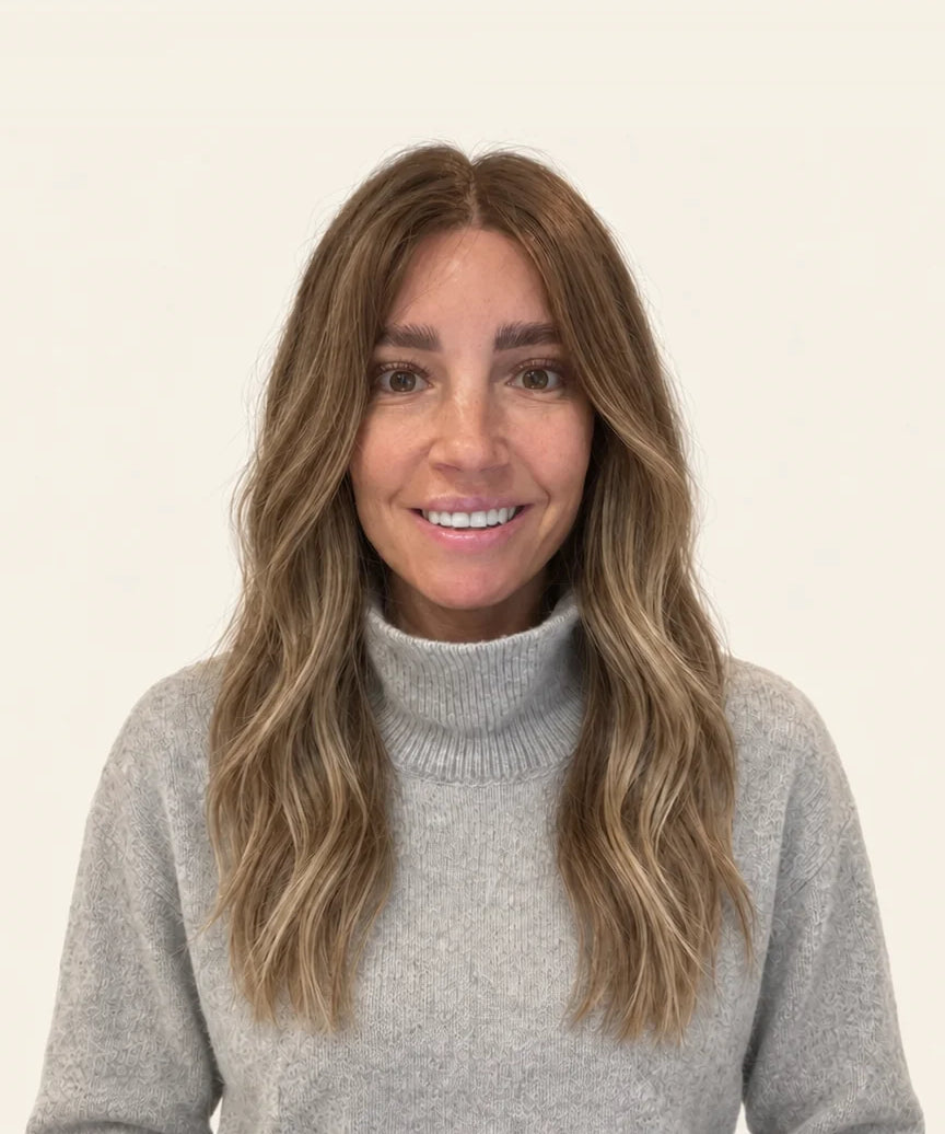 Woman in a grey jumper wearing the 18-inch Midi human hair wig, front view showing where the 18-inch length falls