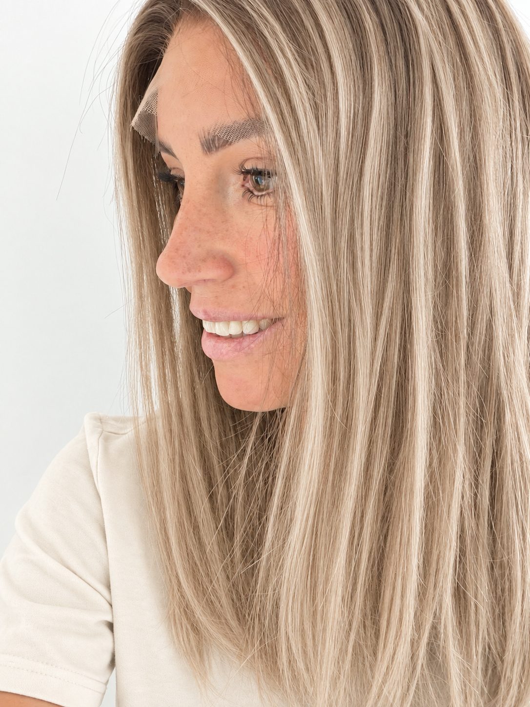 Vanilla Sand 16-inch layered straight wig in rooted beige blonde, side view showing the hairline