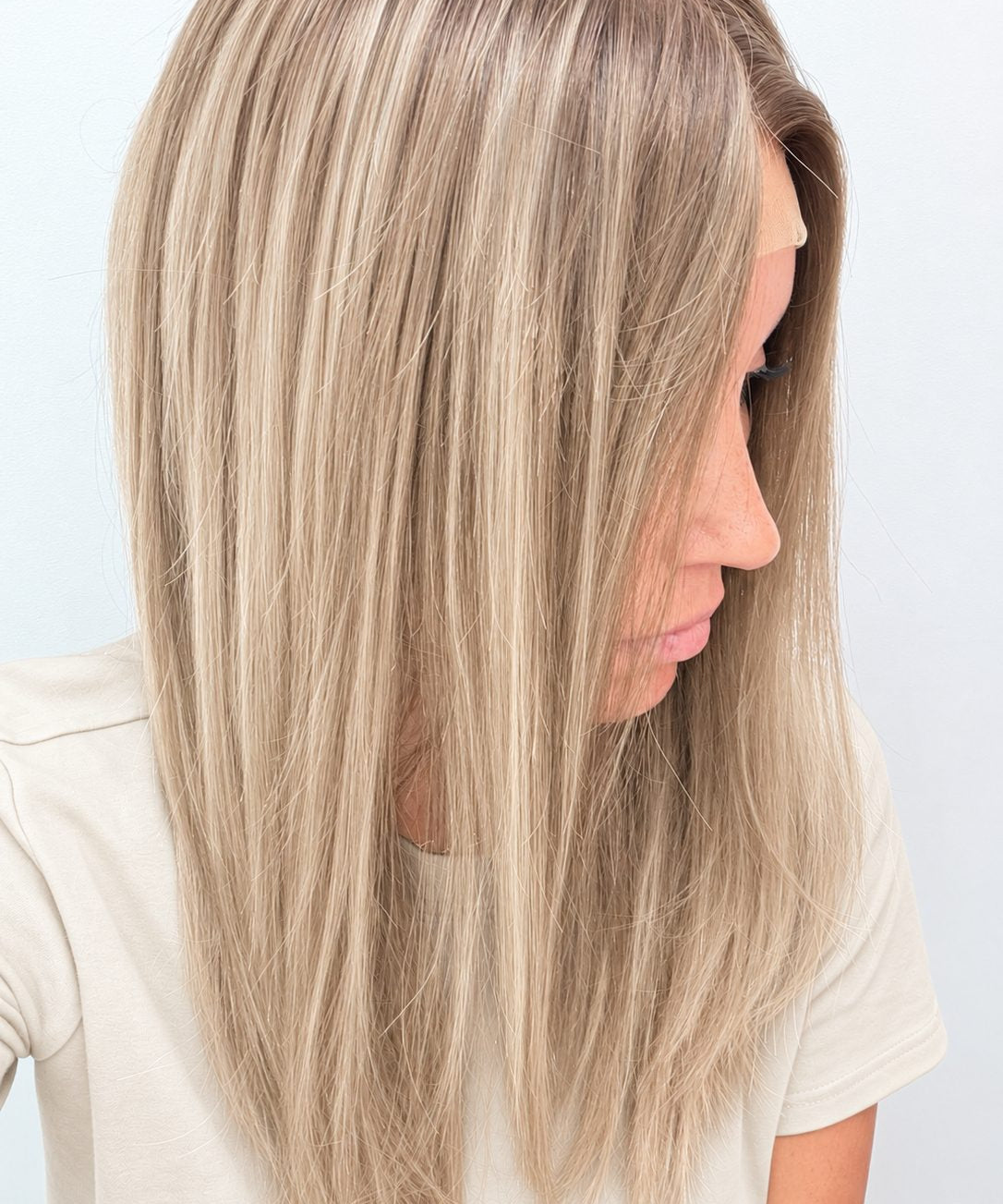 Vanilla Sand 18-inch layered straight wig in rooted beige blonde, side view showing the hairline